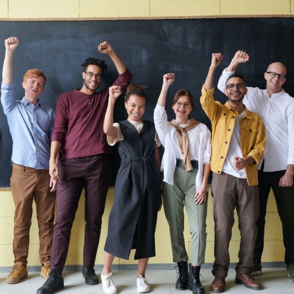 Group of People Standing infront of Blackboard